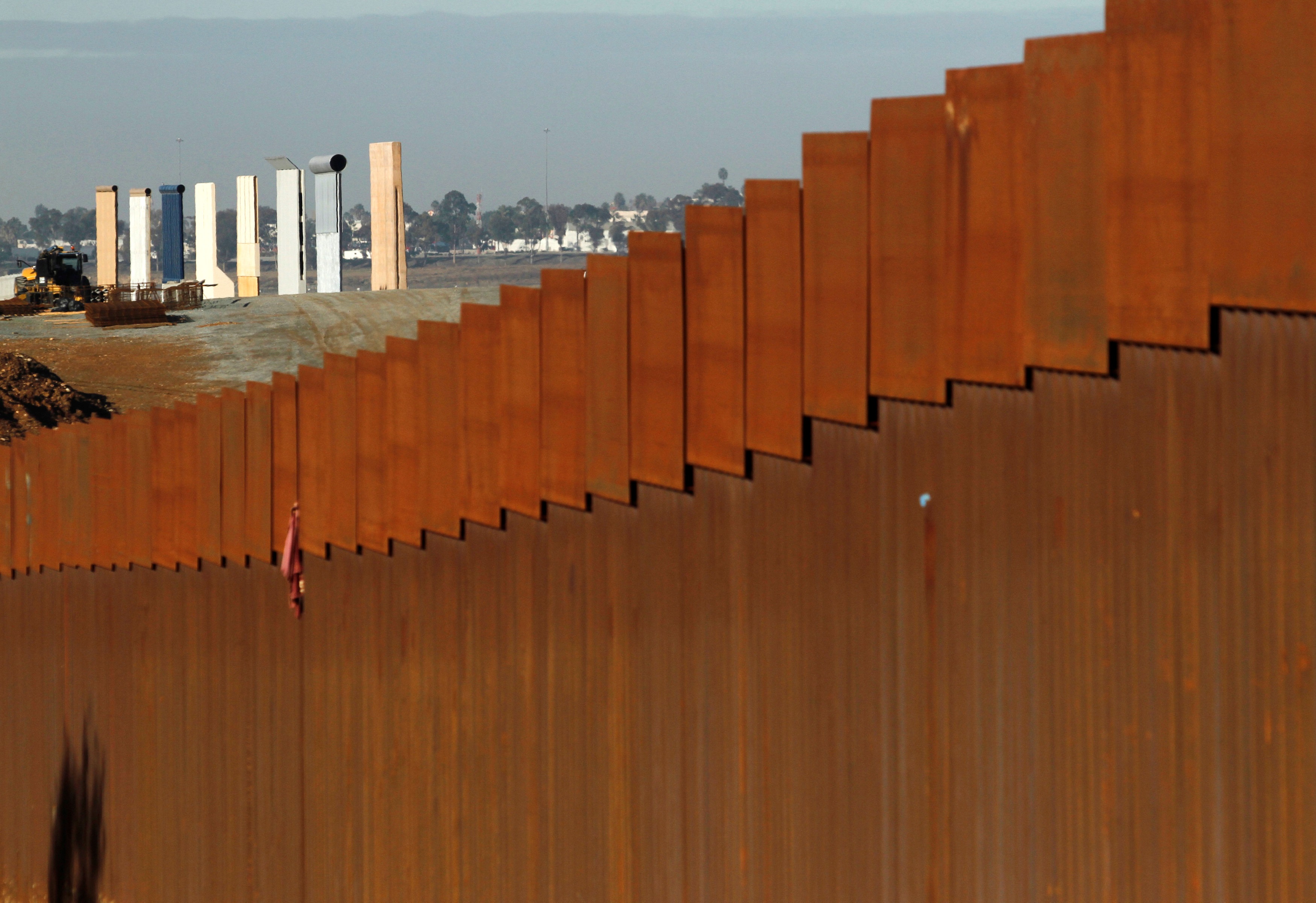 The prototypes for Donald Trump's border wall are seen behind the border fence between Mexico and...