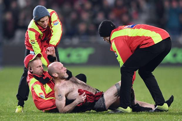 A streaker is stopped by security during the round 5 Super Rugby Aotearoa match between the...