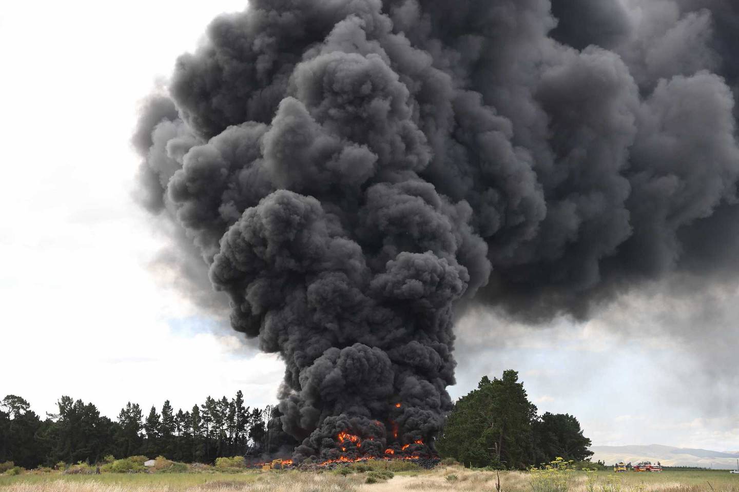 Smoke billows into the air from the tyre fire. Photo: George Heard / NZH