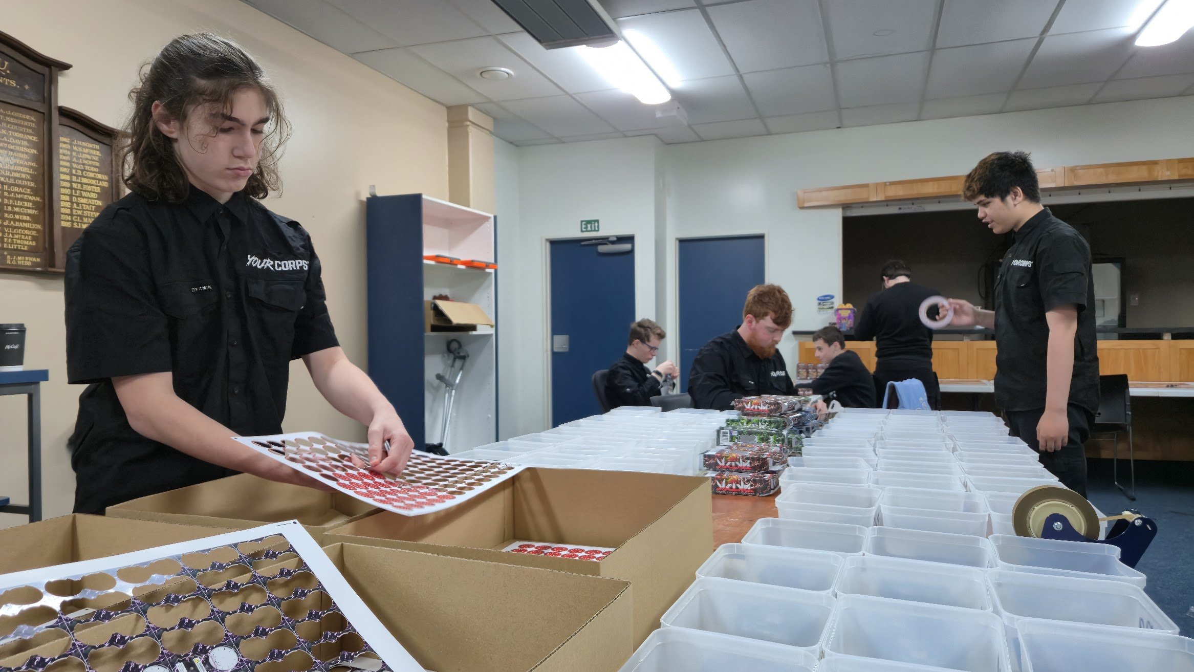 Your Corps youth staff working on TAKTYK, a new card game being launched this week in...