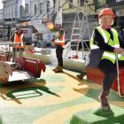 Park Central playground auditor Tina Dyer takes a ride on a new seesaw in George St as part of a...